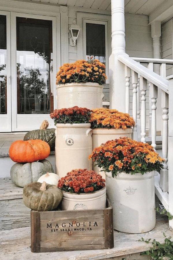 Image of a front porch with flowers and pumpkins
